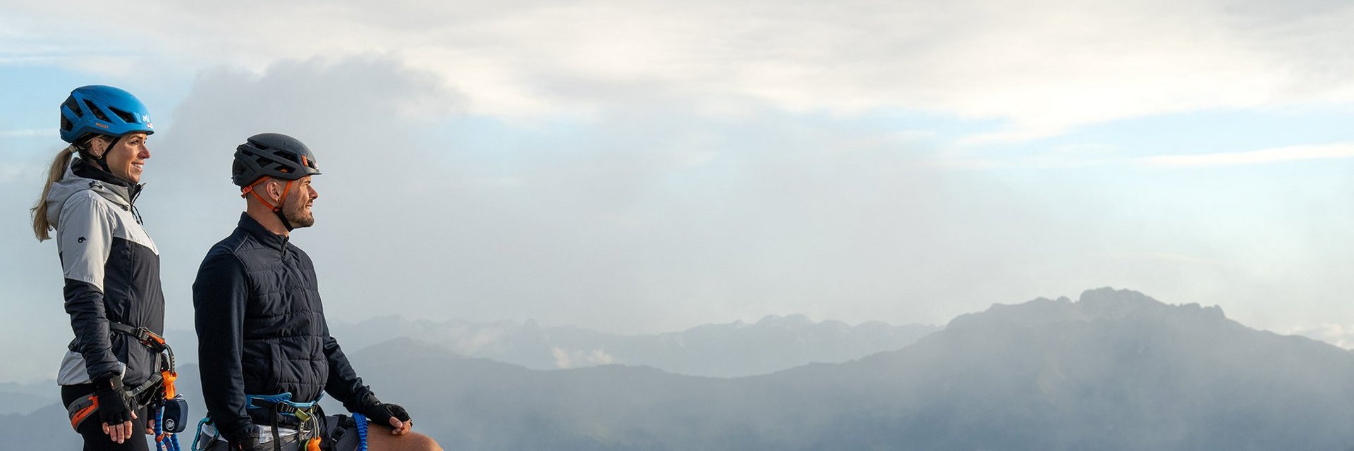 Dieses Bild zeigt ein Paar, dass nach einem absolviertem Klettersteig auf der Schlossalm zufrieden in die Ferne sieht und die Berge bewundert
