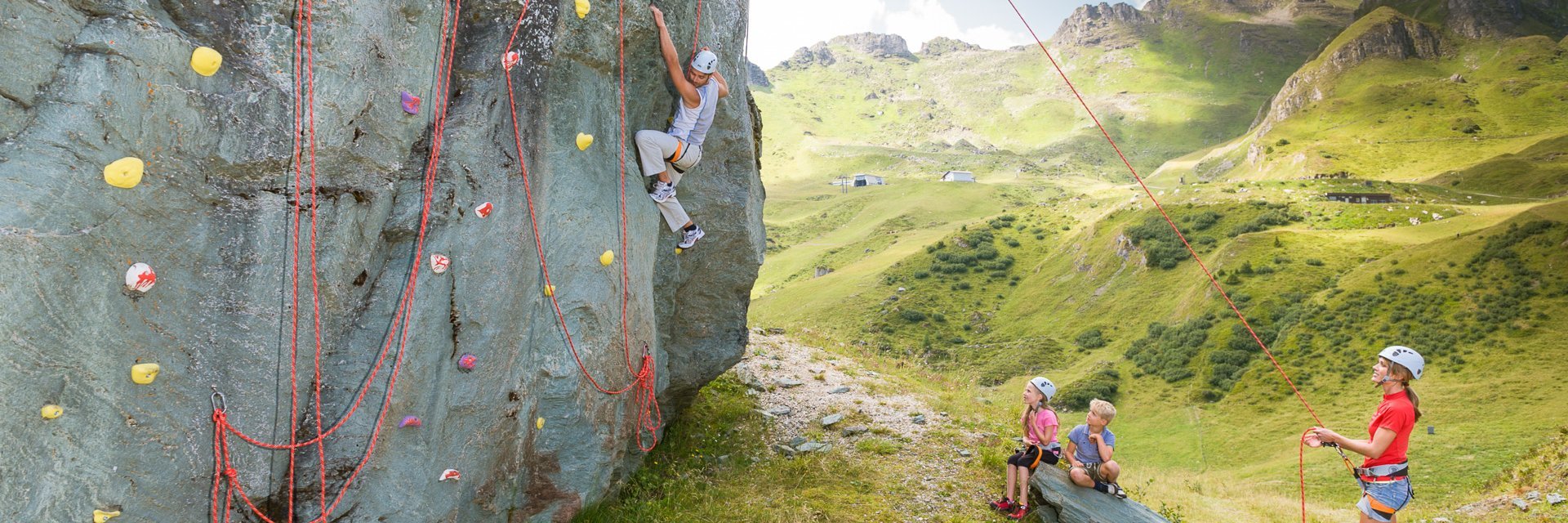 Dieses Bild zeigt eine Gruppe, die auf der Schlossalm auf einem Felsen klettert